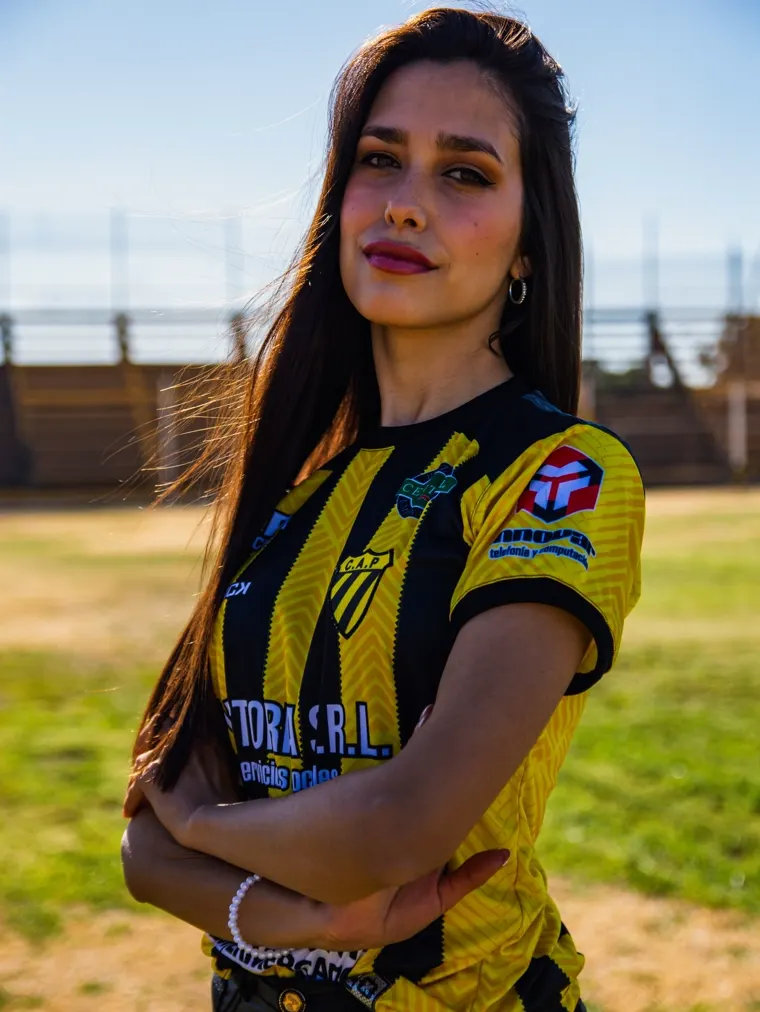 Woman in a yellow and black club shirt