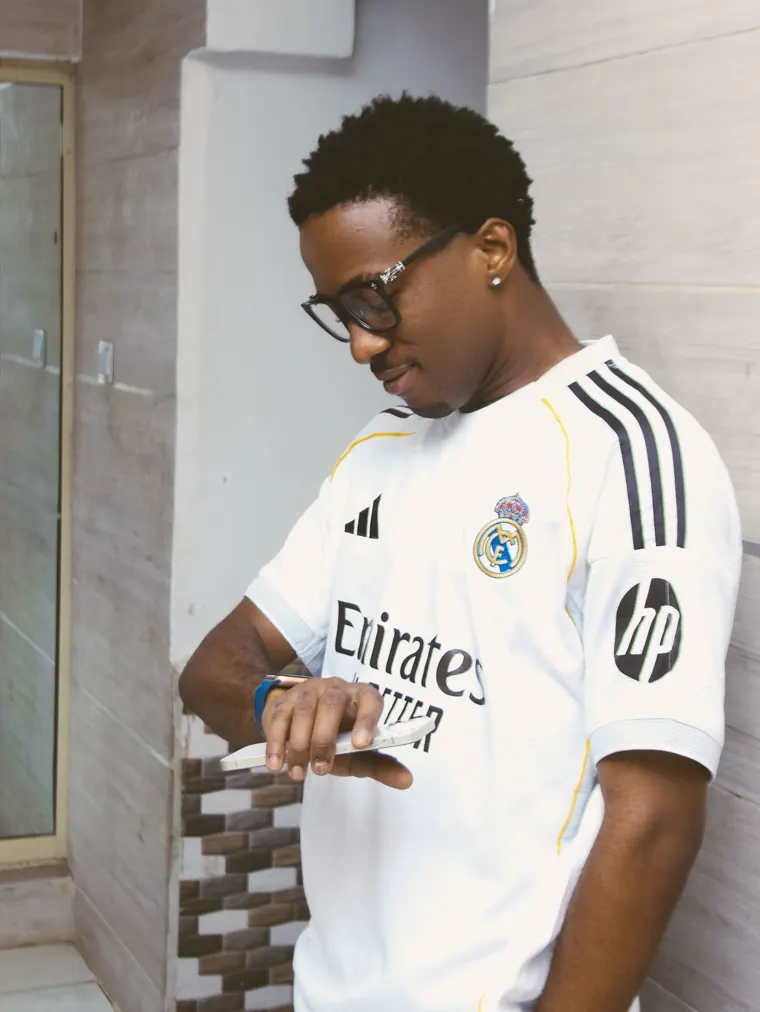 Man in a white club shirt on the street